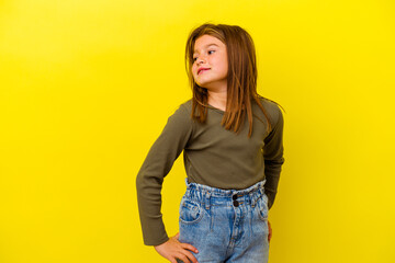Little caucasian girl isolated on yellow background relaxed and happy laughing, neck stretched...