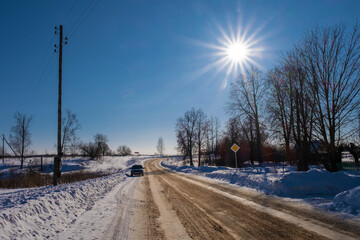 A sun disk with many rays against a blue sky.