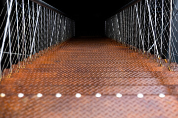 rusty wet metal staircase leading down, stairs down to darkness, fear, danger, space for text
