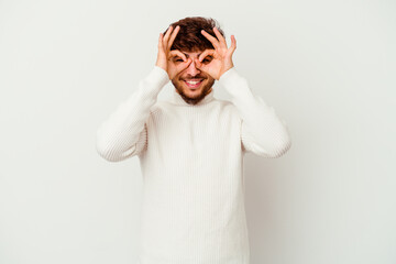 Young Moroccan man isolated on white background excited keeping ok gesture on eye.