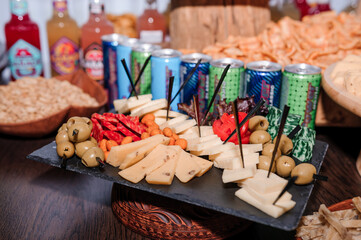 Slicing different types of cheese and olives. Buffet