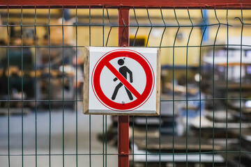 no-entry sign on the fence at the factory