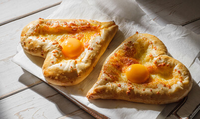 two khachapuri in the shape of a heart. dinner in a Georgian restaurant for two on Valentine's Day