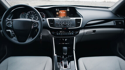 Modern car Interior. Steering wheel, shift lever and dashboard. Detail of modern car interior. Automatic gear stick.