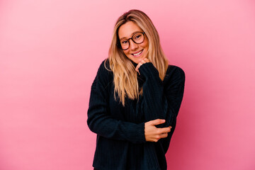 Young mixed race woman isolated on pink background smiling happy and confident, touching chin with hand.