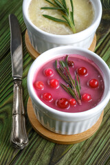 Cranberry pâté and butter pâté in ramequin on a rustic background.