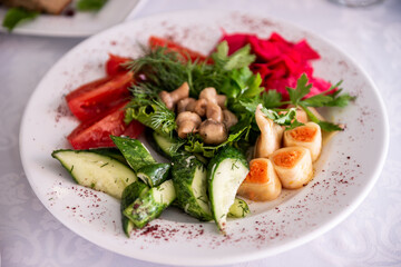 Vegetable salad with cucumber, tomato, cheese, toast, mushrooms, herbs