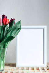 Poster with copy space in cool shades . Mockup of a wooden frame with tulips. White, minimalism. copy space. Mock up design.