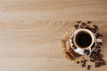 white cup of coffee, coffee beans, cinnamon, anise, background, view from above