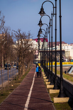 Children walking on a sidwalk with poles  in Iasi, Romania