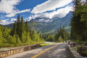 Bikers on the Going-to-the-Sun Road with mountain background, Glacier National Park, Montana