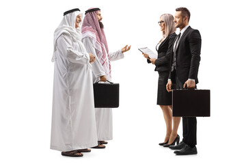 Full length profile shot of a businessman and businesswoman talking to two arab men