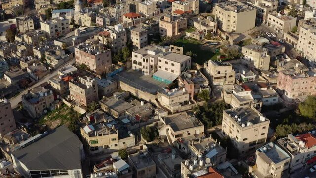 Drone video of a city with Arabic old architecture. Central part with historic houses and their roofs on the streets in the cityscape. Aerial view Amman Jordan.