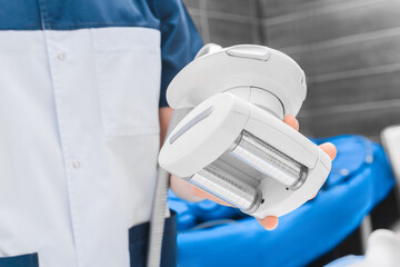 Close-up of roller vacuum massager in doctor's hand.