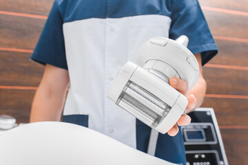 Close-up of a roller vacuum massager in a doctor's hand. Lpg anti-cellulite massage.