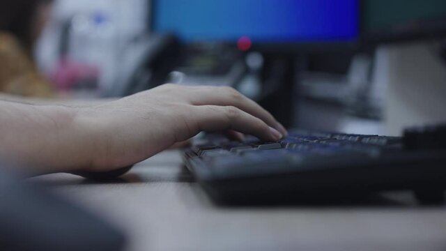 close up computer programmer man hand typing configuration on keyboard at laptop for input coding language to software for fix bug and defect of system in data center room , engineering and technology