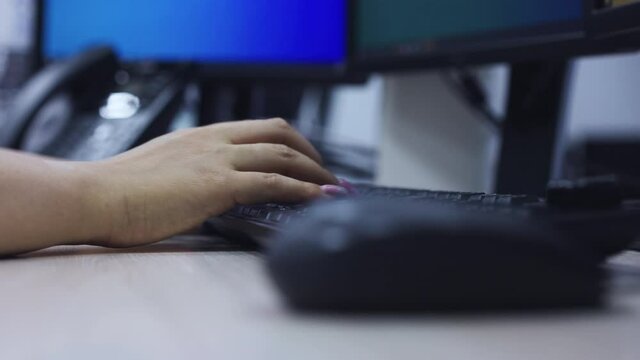 slow motion scene of employee woman hand working and typing on keyboard computer desk  in office room concept