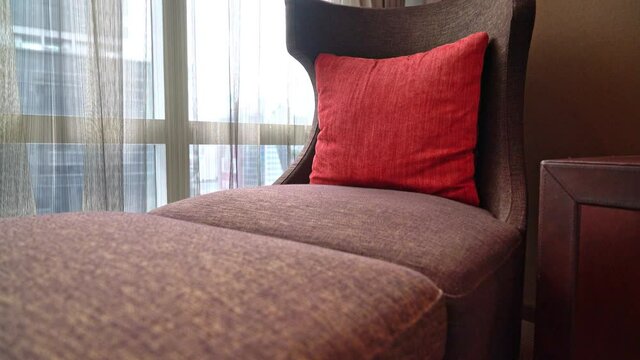 pillow on sofa bed near window