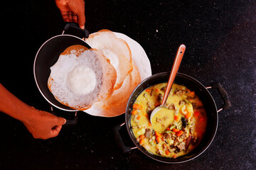 traditional kerala food speciality, appam and stew known as crispy rice pan cake