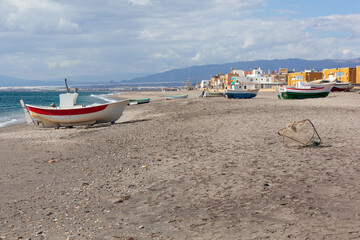 Fishing boats and scenic village on the shore of the Mediterranean sea in Cabo de Gata natural park near Almeria, Spain.