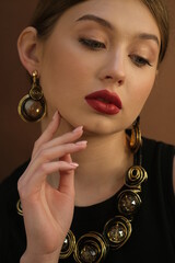 Obraz premium Beauty Portrait. Fashion Brunette Girl. Jewelry Accessories. Beautiful model girl with shiny brown and straight long hair. Keratin straightening. Treatment, care and spa procedures. Smooth hairstyle