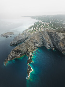 Aerial view of the wild landscape with rocky promontory near La Pelosa town facing the Mediterranean Sea, Sassari, Sardinia, Italy.