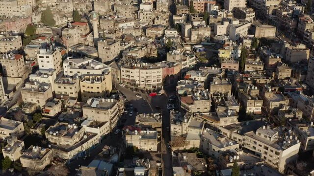 Drone video of the historic center of the Arab city. city ​​life with traffic on the streets on which stand the old houses in the cityscape.Aerial view Amman Jordan.