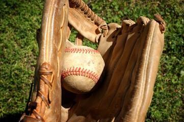 Person catching baseball in web of glove