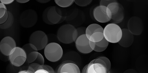 Black and white glitter light effect bokeh on circle pattern background. defocus