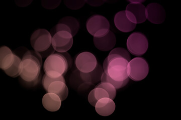 Abstract Christmas bokeh background on pink-purple circle light effects colours.