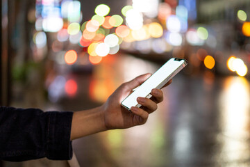 道の上でスマートフォンを開く人