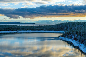 Yellowstone lake at sunrise with snow in autumn, Yellowstone national park, Wyoming, United States of America (USA).