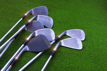 Golf clubs Many equipment for playing golf on a green lawn background.