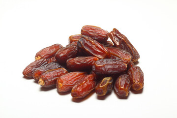 Dates on a white background. Dried fruits. Dried dates lie next to each other	
