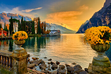View of the beautiful Lake Garda surrounded by mountains, Scenic view of sunset at Lake Garda in...