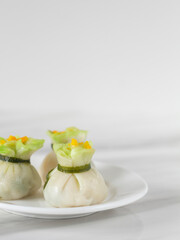 Steamed Money Bag Wontons on White Background with Copy Space. Chinese New Year Dim Sum. Chinese Fine Dining Har Gow (Crystal Shrimp Dumplings) Close Up.