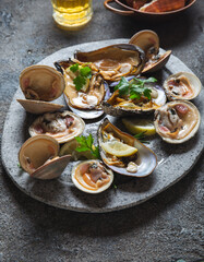 Fresh seafood shellfish mussels, clams, crabs and snails on gray background