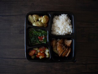 Asian Bento Box Flatlay on Wooden Table. Asian food bento for quarantine at home.