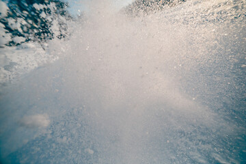 snow splash in the air, blue sky background