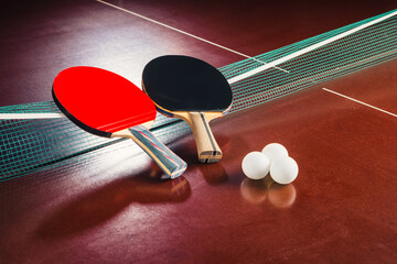 table tennis rackets on the net and balls