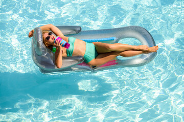 Sensual woman on summer vacation. Suntan. Girl in swimmsuit. Summertime woman on inflatable mattress.