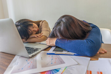 Tired Asian office woman sleeping in the office