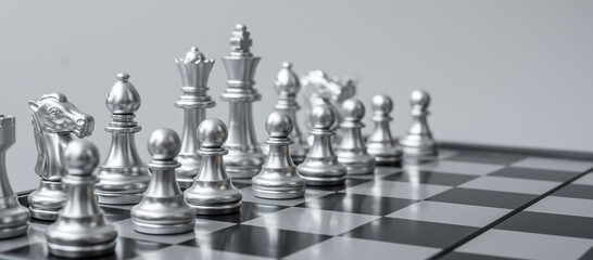 silver Chess figure team (King, Queen, Bishop, Knight, Rook and Pawn) on Chessboard against opponent during battle. Strategy, Success, management, business planning, think,education and leader concept