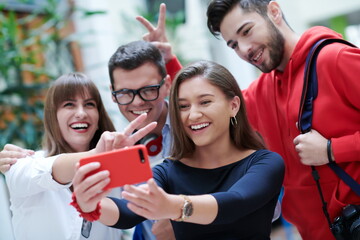 Obraz premium Group of multiethnic teenagers taking a selfie in school
