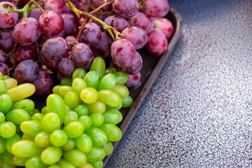 red grape and green grape on the table, selective focus point