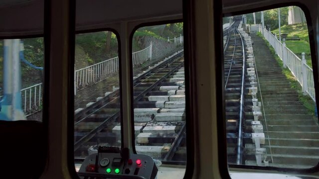 Interior clip of Kiev Funicular as it descends from Volodymyrska Park station. Another train passes.