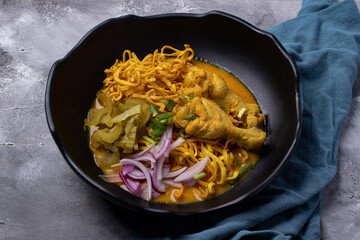 Khao Soi Recipe, Northern Style Curried Noodle Soup with Chicken in a black plate.