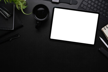 Top view of modern workplace with mock up digital tablet, coffee cup, stylus pen, smart watch and...
