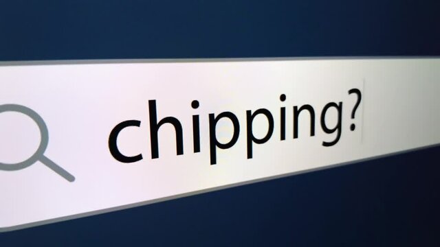 Chipping written in search bar with cursor and question mark at the end,a computer monitor, close-up with the effect of a camera zoom