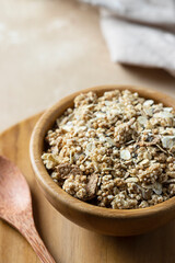 Wooden bowl with mix of unprocessed whole grains, chia, quinoa, nuts, seeds with chocolate .